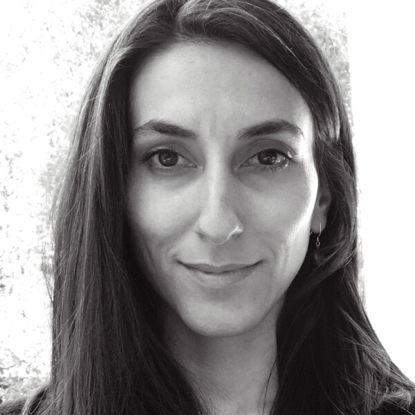 A black and white photo of a researcher with long dark hair
