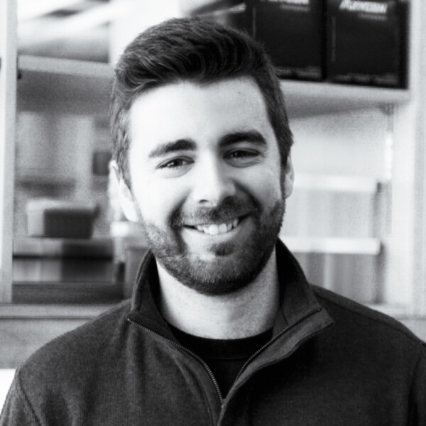 A black and white photo of a researcher with a beard