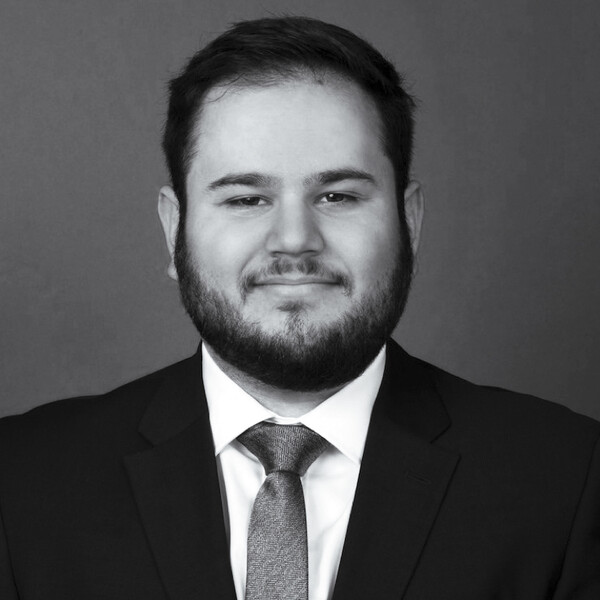 A black and white photo of a researcher in a suit and tie