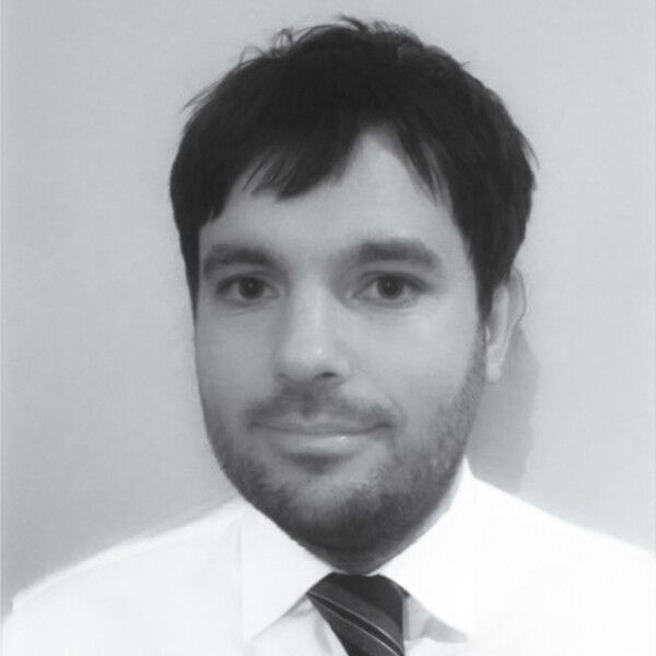 A black and white photo of a researcher in a white collared shirt
