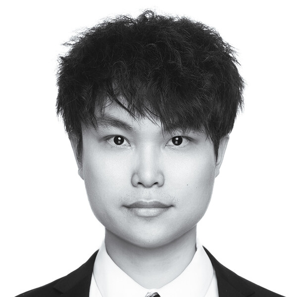 A black and white photo of a researcher with short black hair